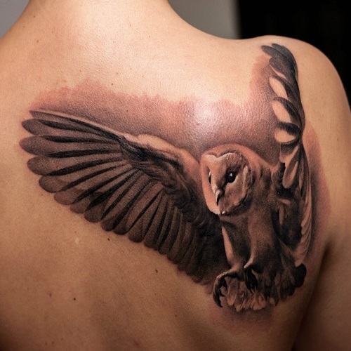 татуировка сова с распахнутыми крыльями на спине
